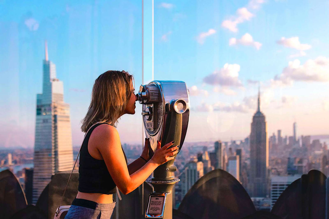 Woman using a tower viewer in New York City 