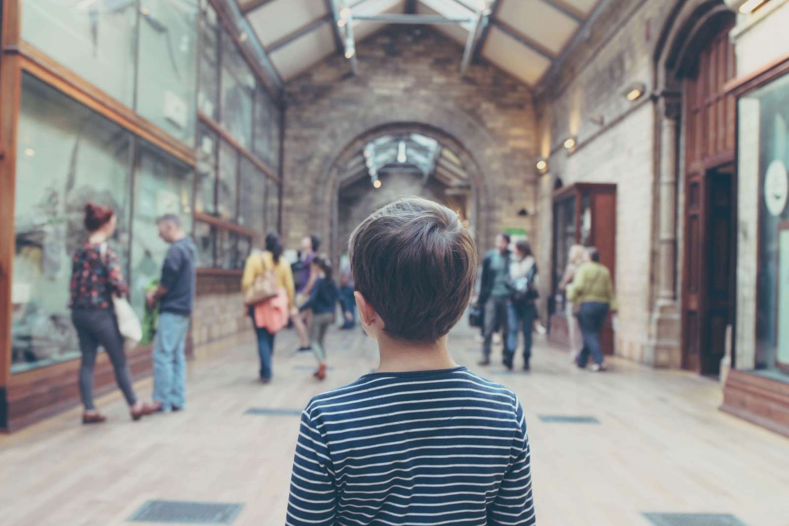 little boy walking around a historic museum