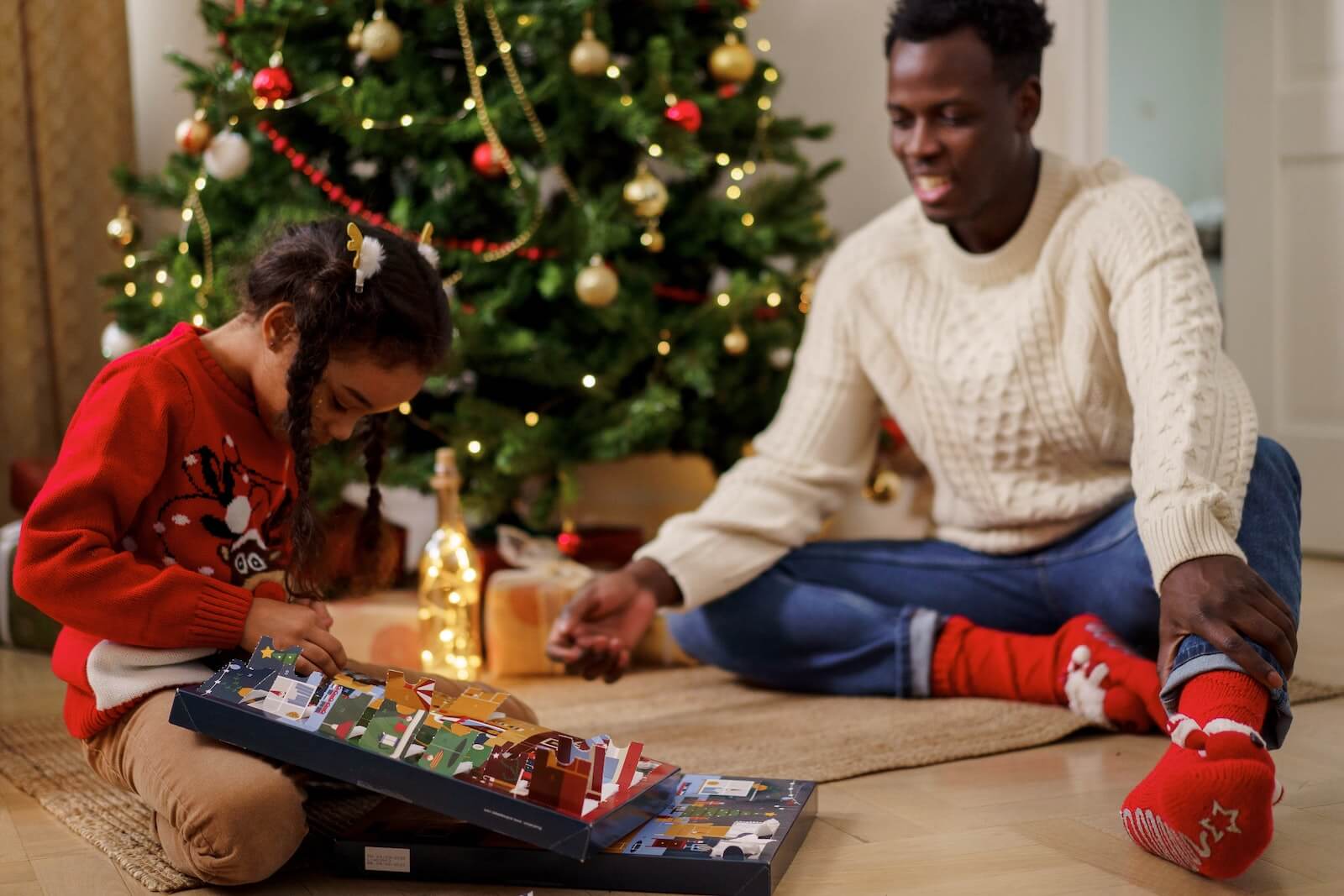 Father and daughter opening advent calendar for holiday season