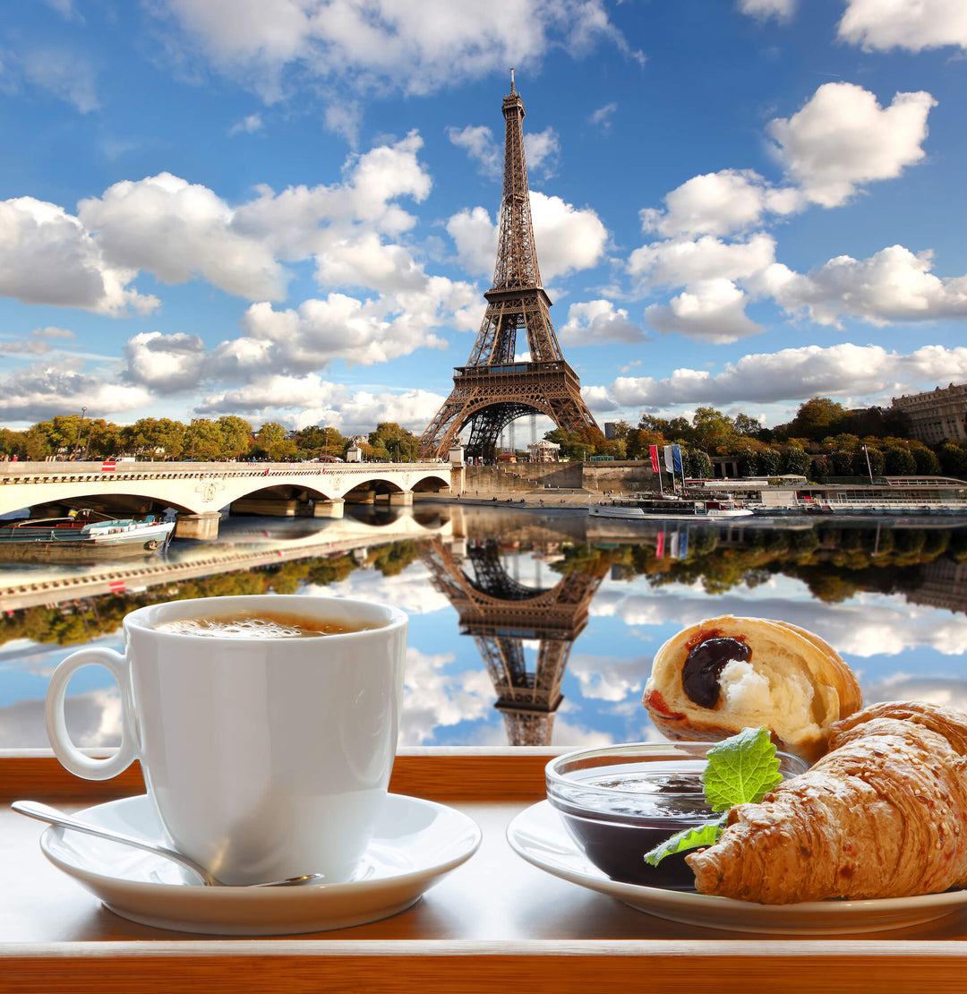 Croissant with fruit and coffee in front of eiffel tower