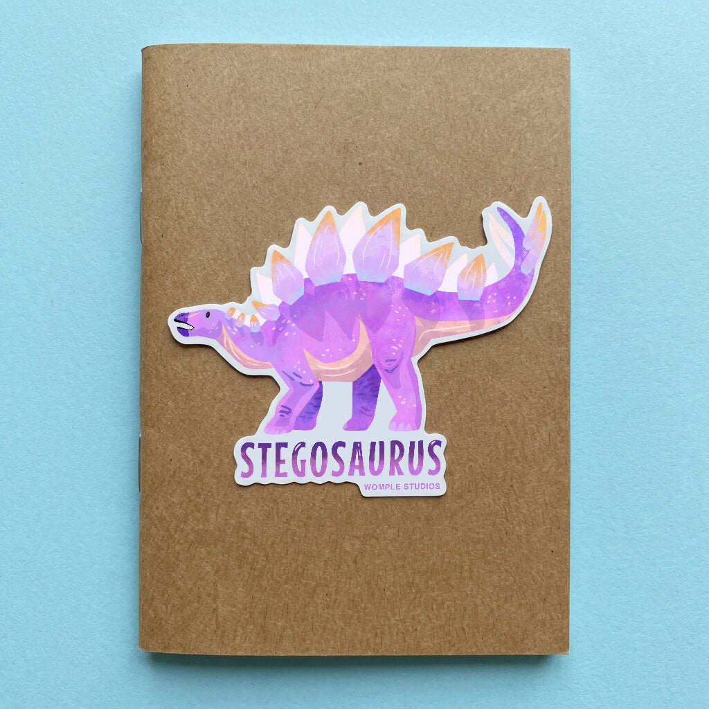 Stegosaurus sticker on a brown notebook with a blue background