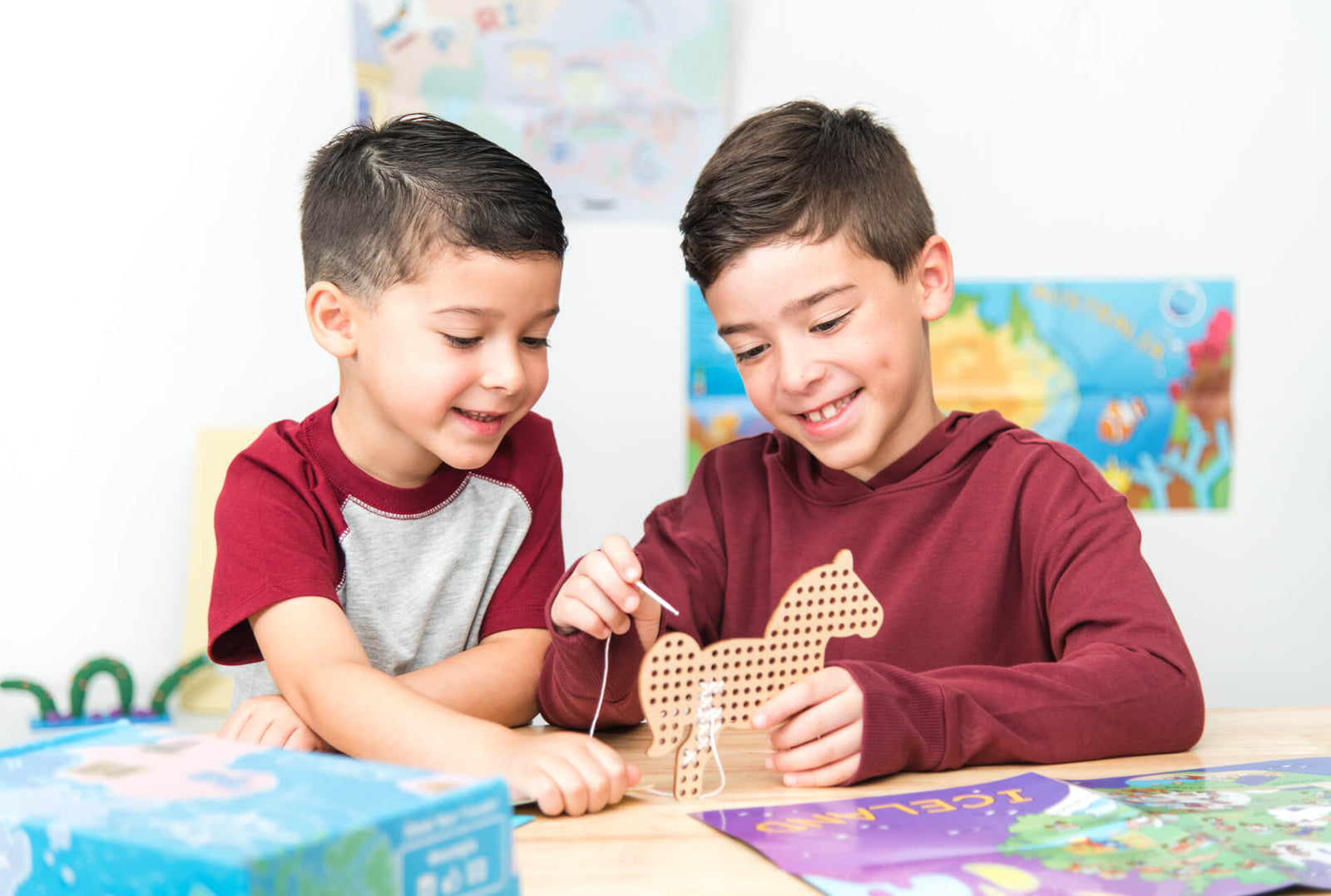 Womple Studios two boys playing with a cross-stitching craft project