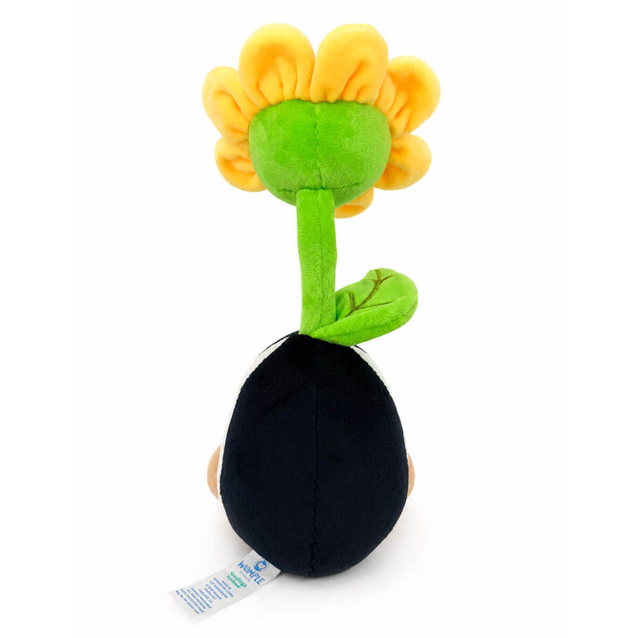 A plush toy sunflower seedling with a bright yellow flower head, green stem and leaf, and a black seed pod base, photographed on a plain white background.